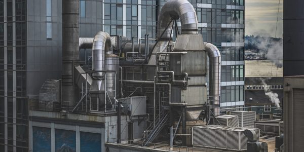 A factory surrounded by high-rise buildings with greenery on the background in Seattle